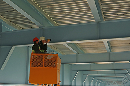 Two bridge inspectors inspecting the Hoan Bridge.