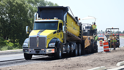 A dump truck and construction workers on W County Line Road