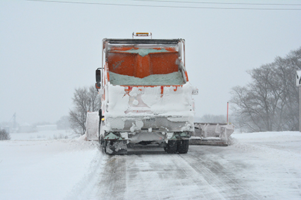 Salt for the roadways in the back of a snow plow.