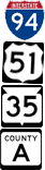 A blue and red I-94 sign. Black and white signs for US 51, WIS 35, and County A.