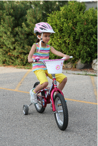 Girl bicycle rider with no loose clothing.