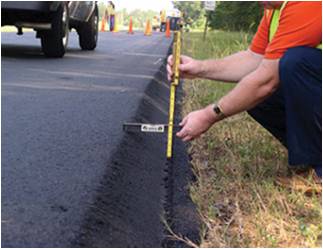 Man measuring road thickness