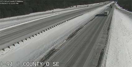 Aerial view showing a clear roadway in the winter.